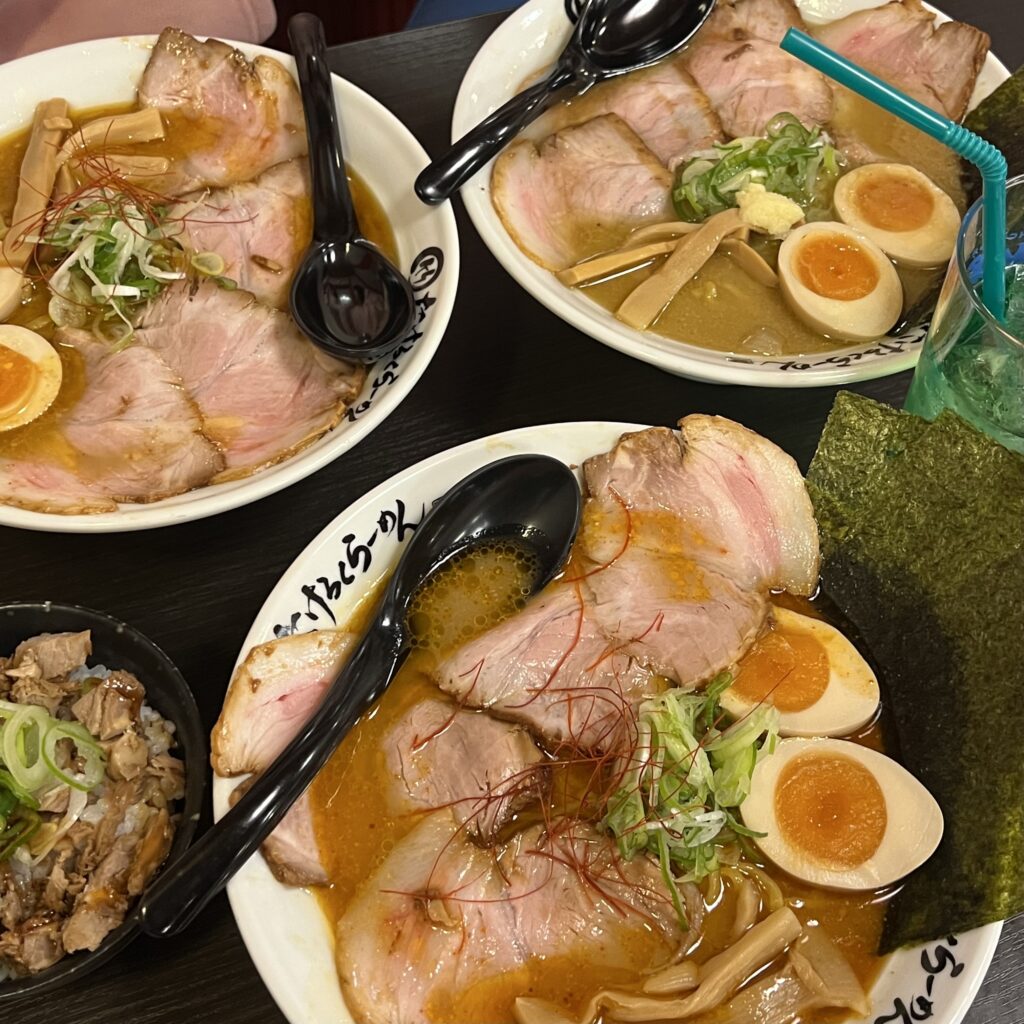 Three bowls of Japanese ramen arranged next to each other.