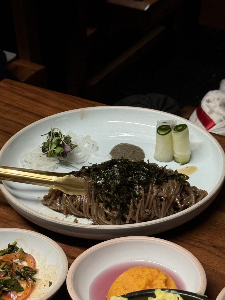 plate of korean perilla oil noodles with tongs