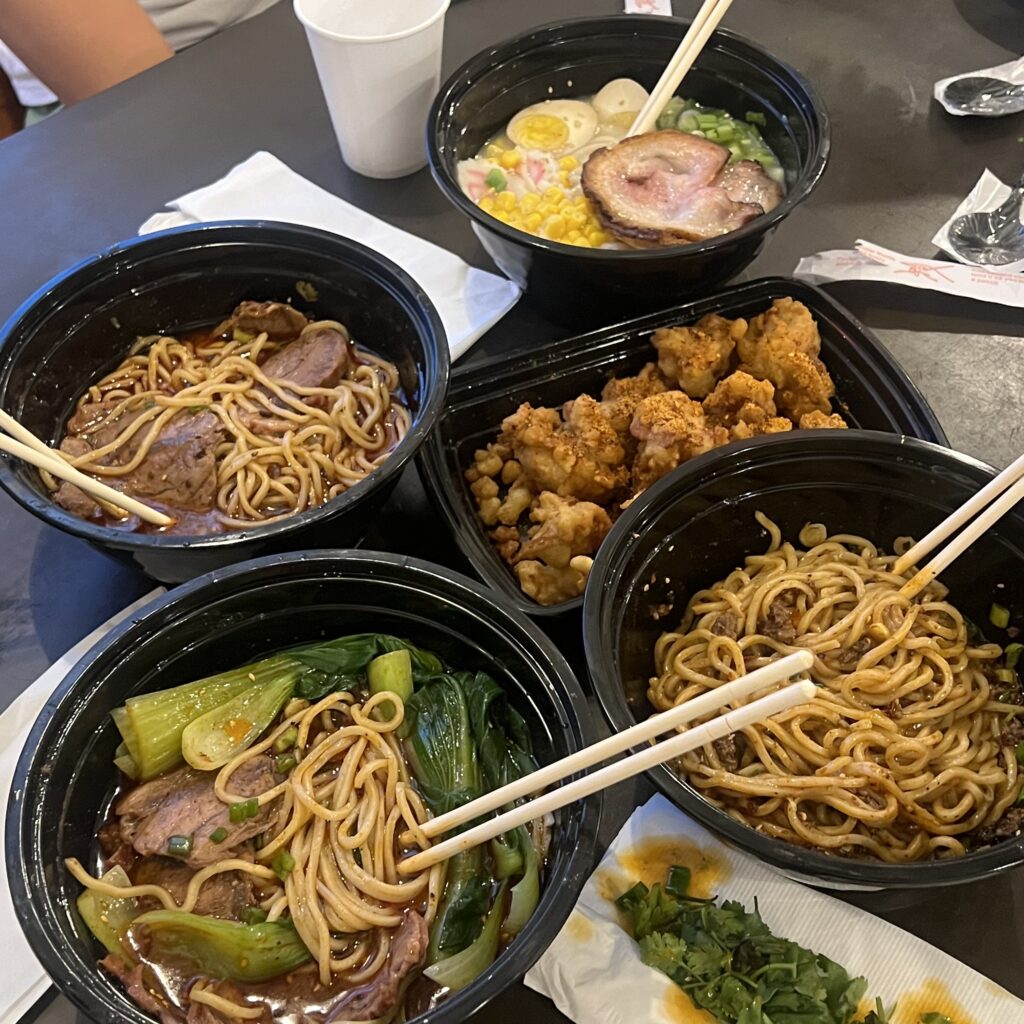multiple dishes of taiwanese noodle soups and popcorn chicken