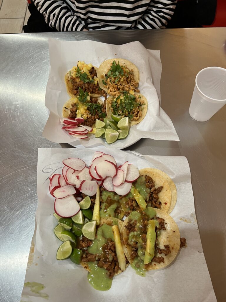 2 trays of street tacos with garnishes