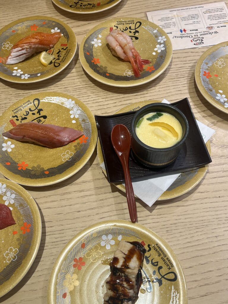 small trays of nigiri and egg pudding