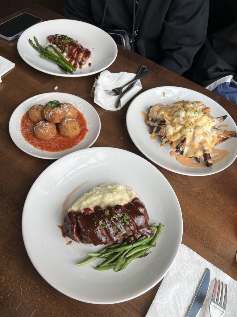 multiple plates of steak, mashed potatoes, falafel