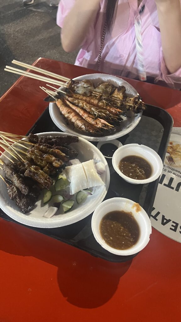 2 trays of bbq skewers on table