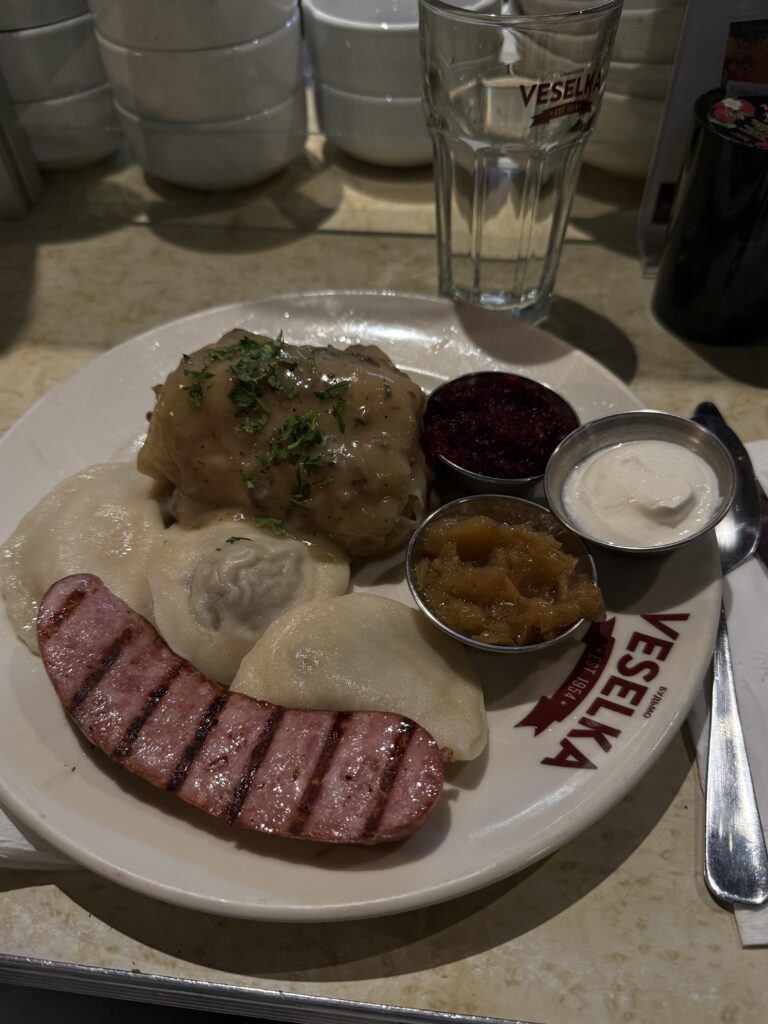plate of Ukrainian stuffed cabbage, pirogi, and sausage