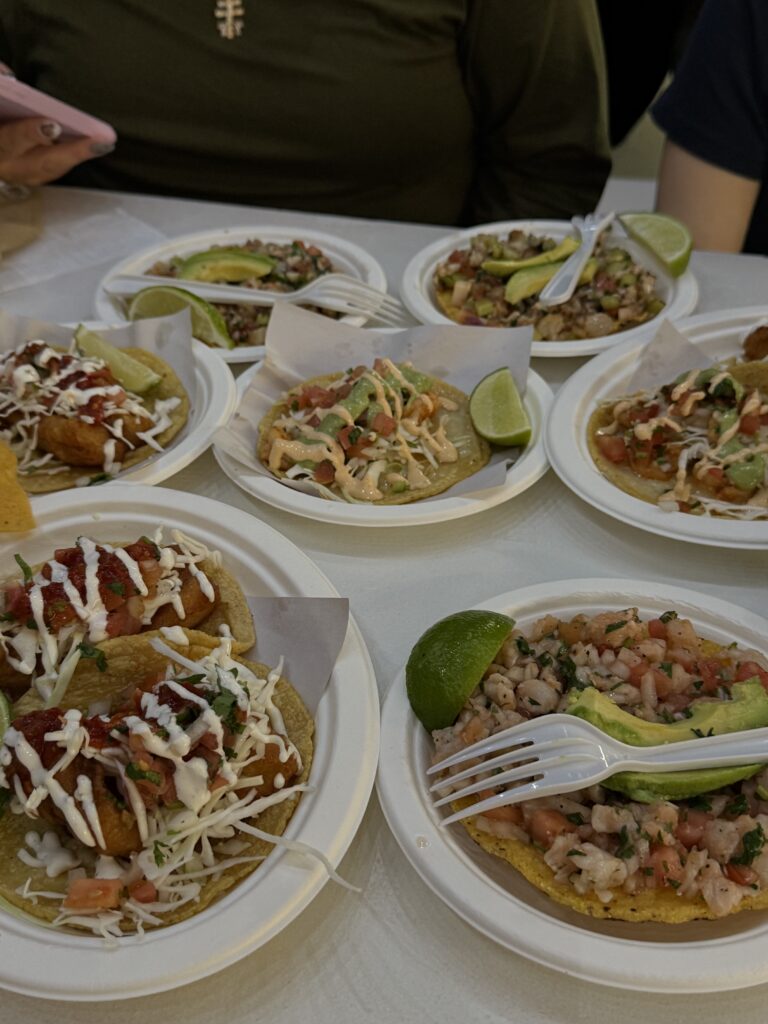 multiple small plates of fish tacos and ceviche