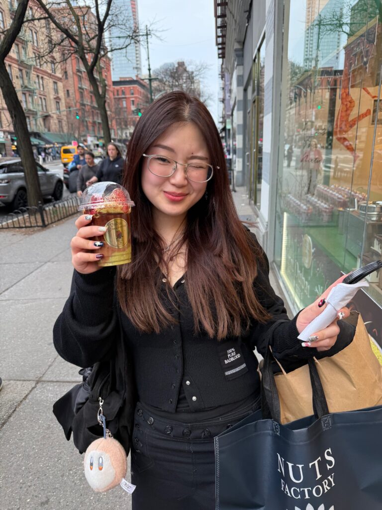 picture of author holding cup of chocolate strawberries