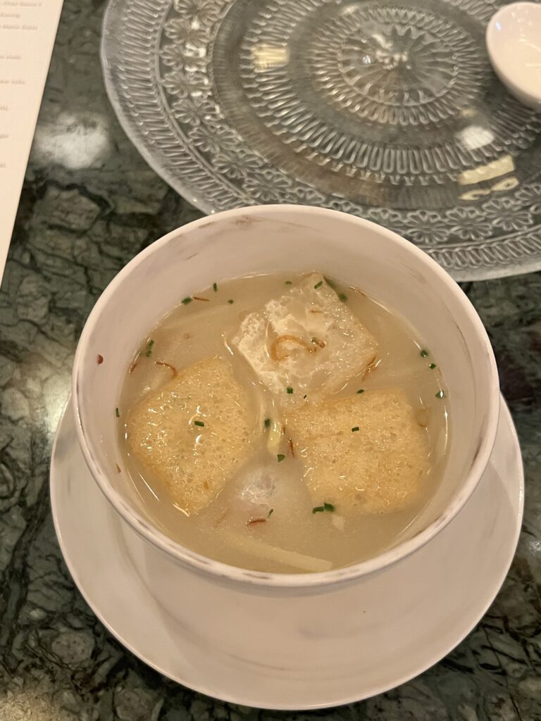 Tofu soup in bowl on table
