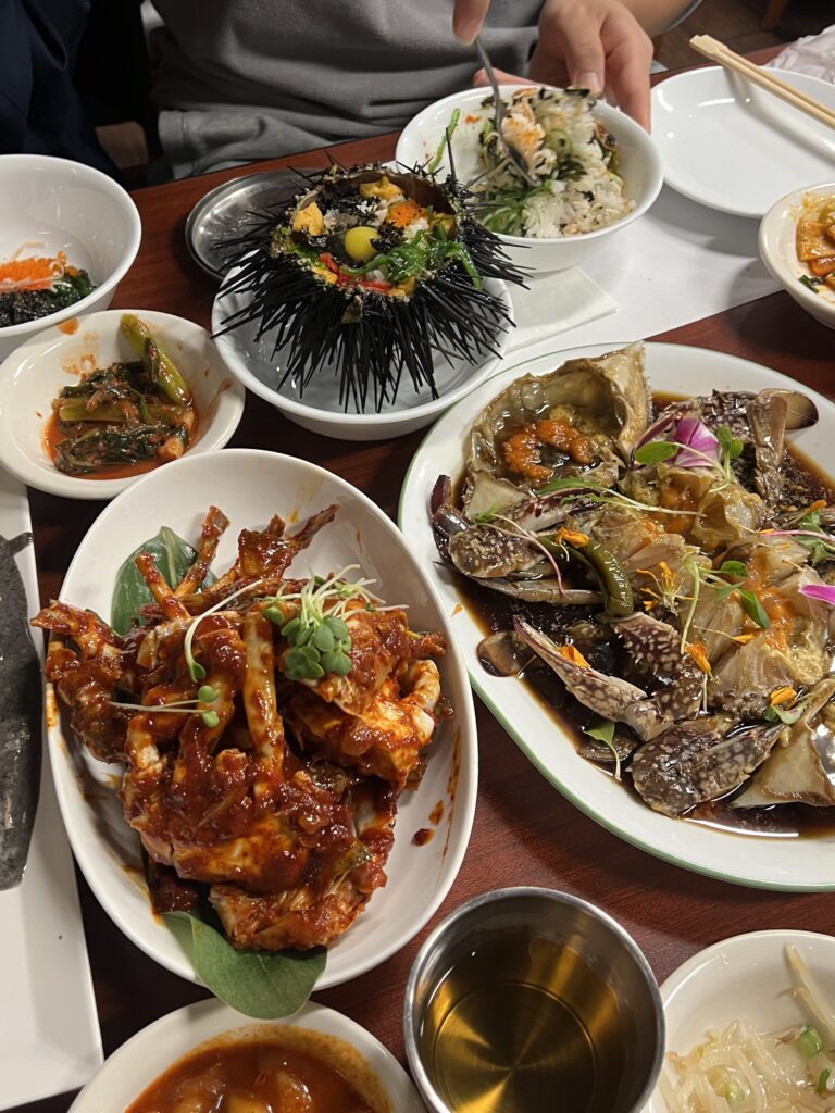 korean spicy and soy raw marinated crab, sea urchin shell with uni rice filling